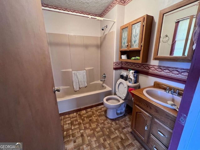 full bathroom featuring toilet, a textured ceiling, shower / bathtub combination, and vanity