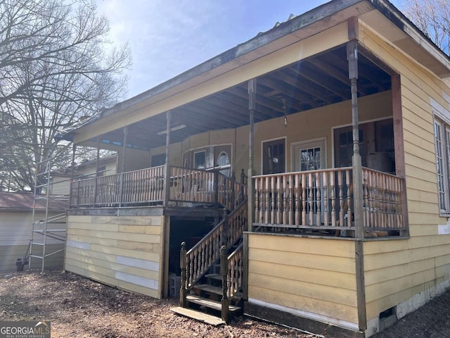 back of house featuring covered porch