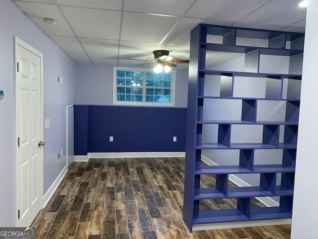 interior space with hardwood / wood-style flooring, a paneled ceiling, and ceiling fan