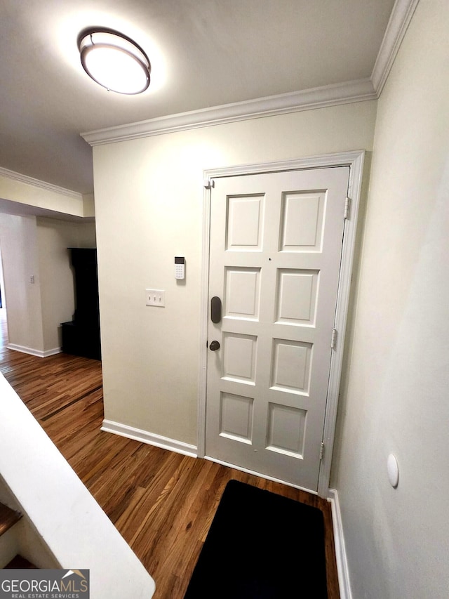 entrance foyer with hardwood / wood-style flooring and ornamental molding