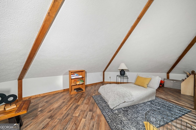 interior space featuring dark wood-type flooring, a textured ceiling, and vaulted ceiling