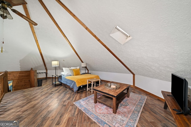 bedroom with dark hardwood / wood-style flooring, a textured ceiling, and vaulted ceiling