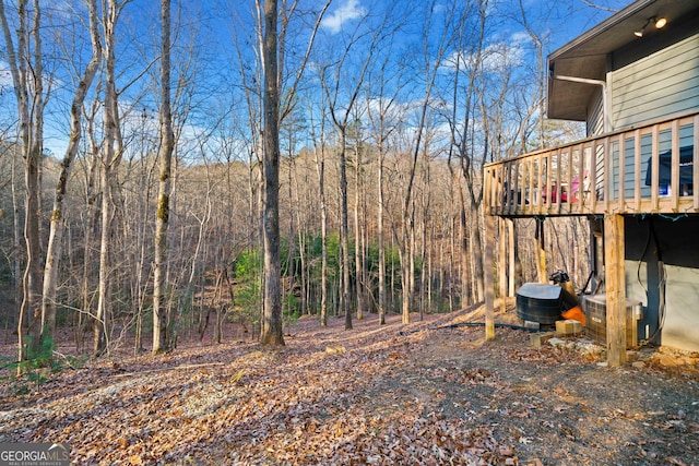 view of yard with cooling unit and a wooden deck