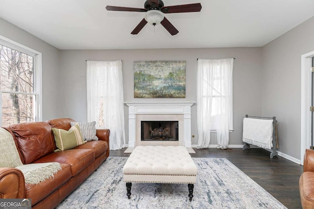 living room with dark hardwood / wood-style flooring and ceiling fan