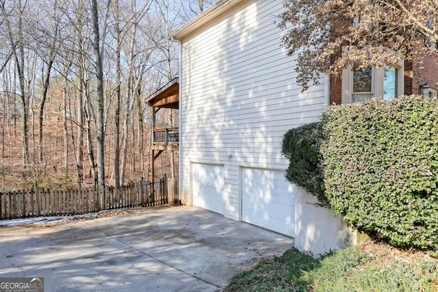 view of side of home featuring a balcony and a garage