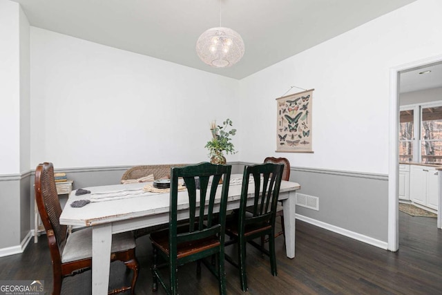 dining space with dark hardwood / wood-style floors