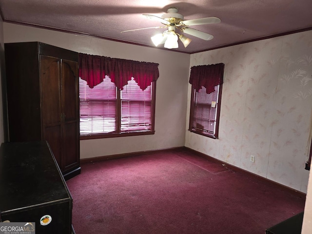 unfurnished room with crown molding, carpet floors, a textured ceiling, and ceiling fan