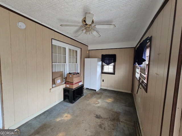 interior space with ceiling fan