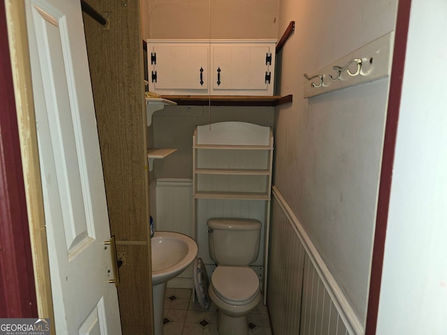 bathroom featuring tile patterned floors and toilet