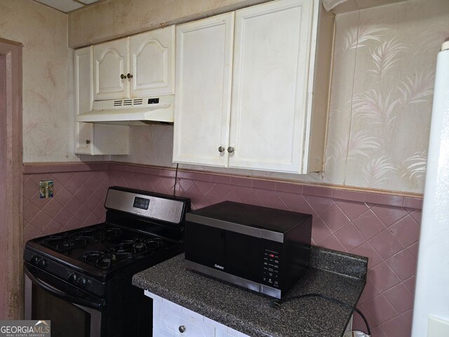 kitchen featuring stainless steel appliances and white cabinetry