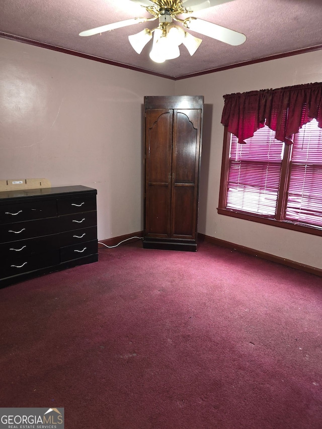 unfurnished bedroom featuring ceiling fan, crown molding, a textured ceiling, and carpet