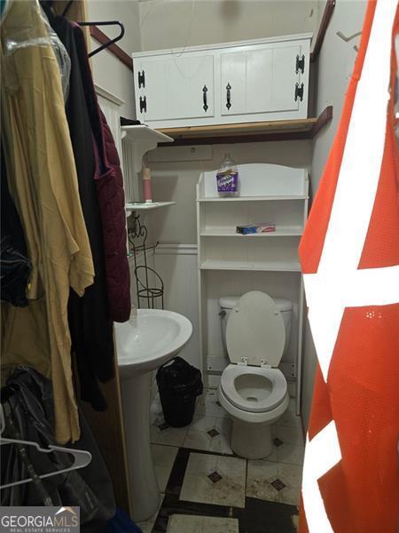 bathroom featuring tile patterned floors and toilet