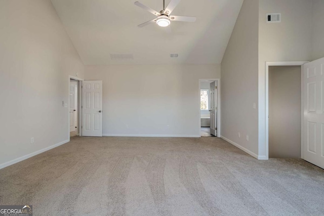 interior space with high vaulted ceiling, light colored carpet, and ceiling fan