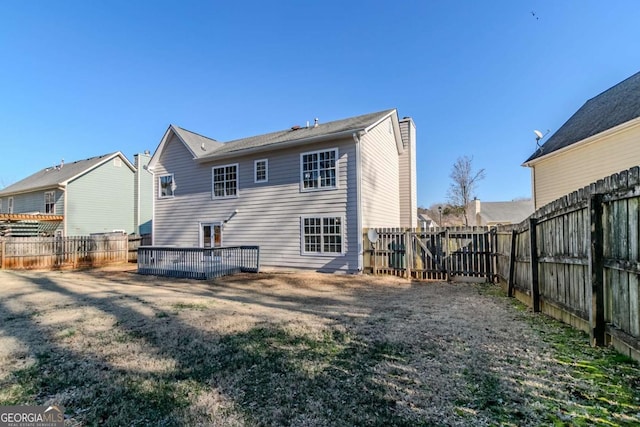 rear view of house featuring a yard