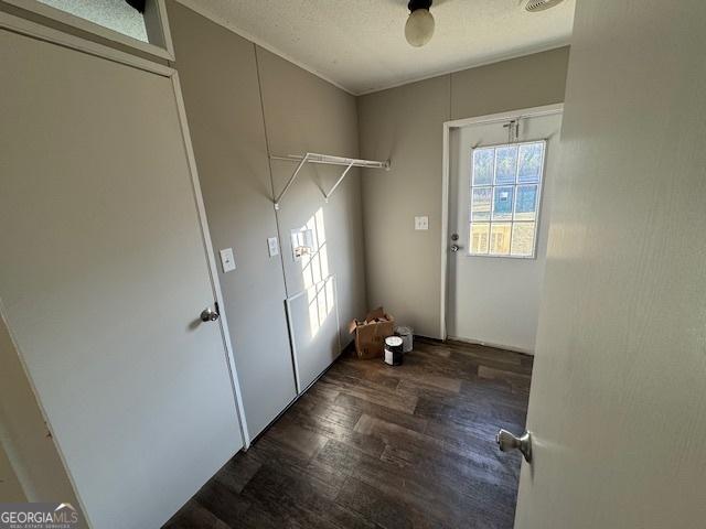 washroom with a textured ceiling and dark wood-type flooring