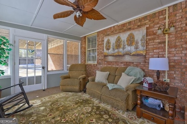 interior space featuring brick wall and ceiling fan