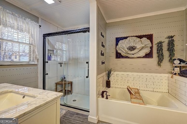 bathroom with shower with separate bathtub, crown molding, and vanity