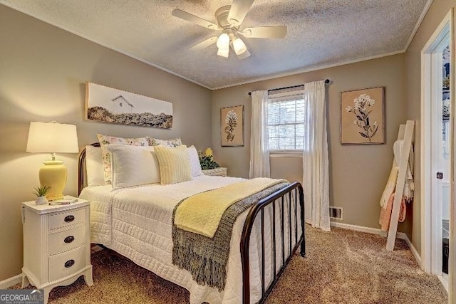 bedroom with a textured ceiling, ceiling fan, crown molding, and carpet floors