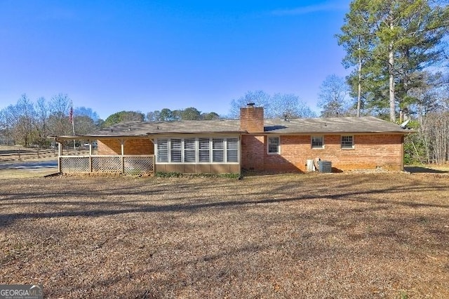 rear view of house featuring central air condition unit