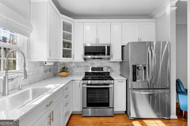 kitchen with sink, stainless steel appliances, and white cabinets