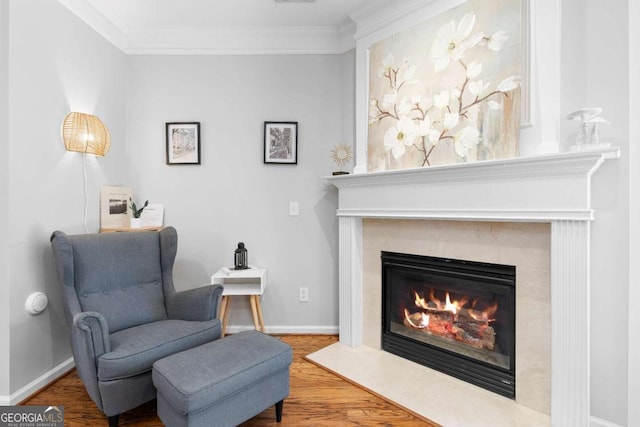 living area featuring ornamental molding and hardwood / wood-style flooring