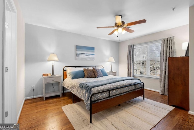 bedroom with ceiling fan and wood-type flooring