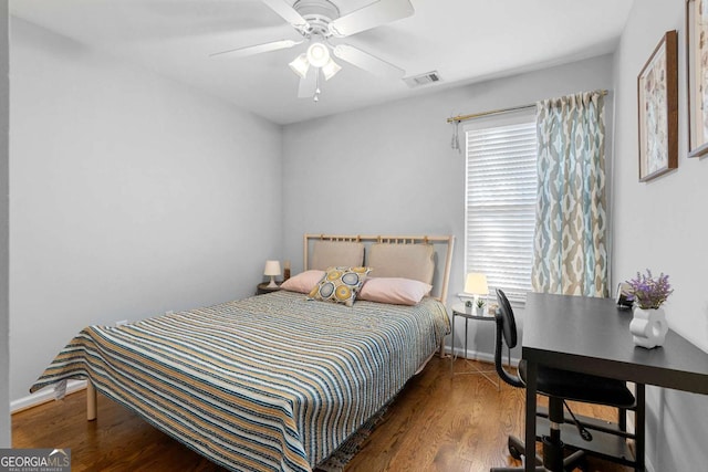 bedroom featuring multiple windows, ceiling fan, and dark hardwood / wood-style floors