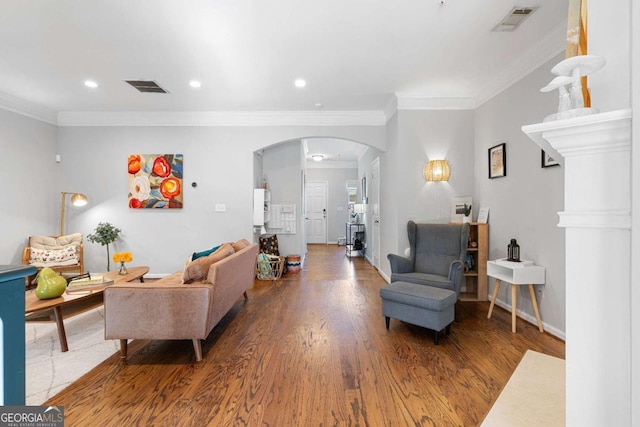 living room with ornamental molding and wood-type flooring