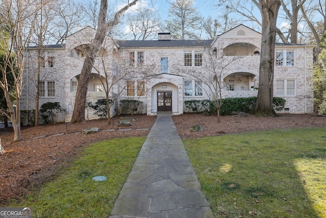 view of front of property with a front lawn and french doors