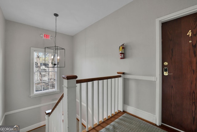 interior space featuring wood-type flooring and a chandelier