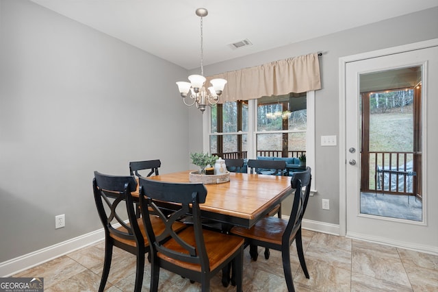 dining space featuring an inviting chandelier