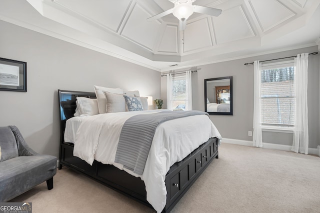 carpeted bedroom featuring ceiling fan, a raised ceiling, crown molding, and coffered ceiling