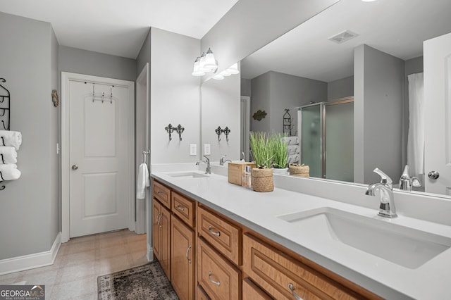 bathroom featuring a shower with shower door and vanity