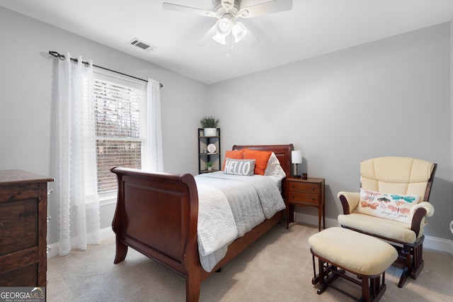 bedroom with ceiling fan and light carpet