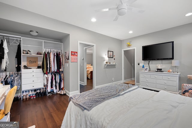 bedroom with ceiling fan, dark wood-type flooring, and a closet