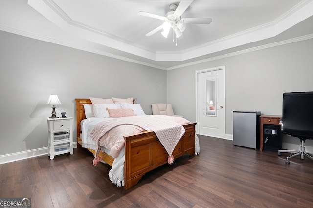 bedroom featuring dark hardwood / wood-style floors, a raised ceiling, stainless steel refrigerator, ceiling fan, and crown molding