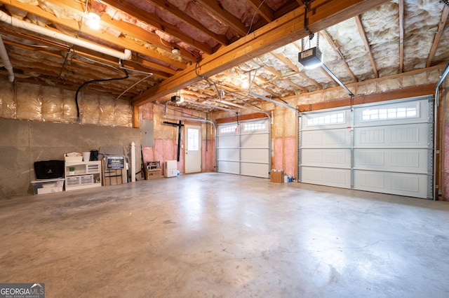 garage featuring electric panel and a garage door opener