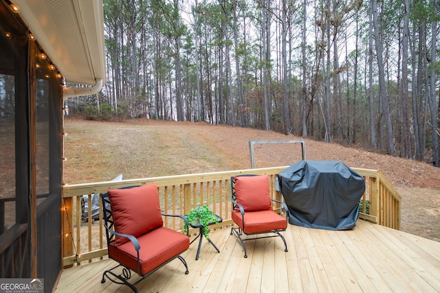 wooden deck with a grill