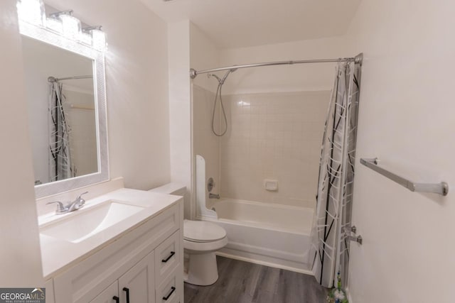 full bathroom with shower / tub combo, hardwood / wood-style floors, vanity, and toilet