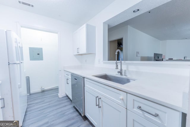 kitchen featuring sink, dishwasher, white cabinetry, and white fridge