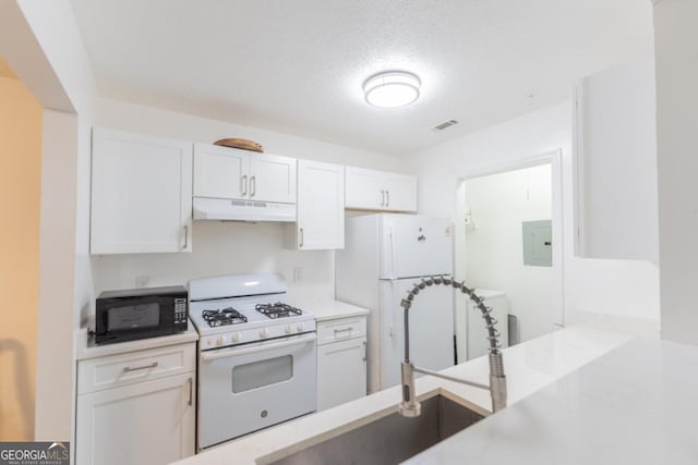 kitchen featuring white appliances, a textured ceiling, electric panel, and white cabinets