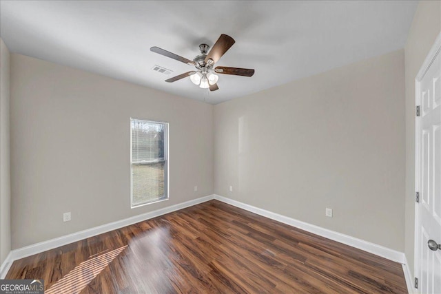 spare room featuring ceiling fan and dark hardwood / wood-style flooring