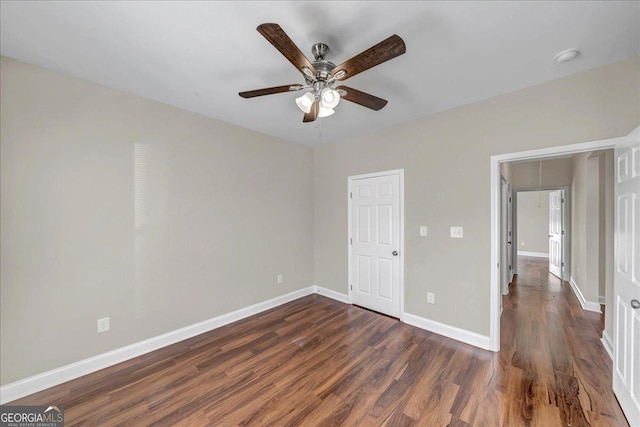 unfurnished bedroom featuring dark wood-type flooring and ceiling fan