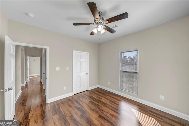 unfurnished bedroom with dark wood-type flooring and ceiling fan