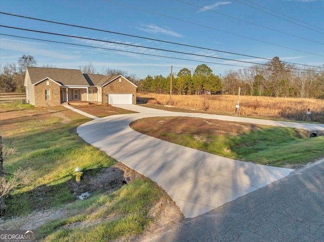 view of front of home with a front lawn and a garage