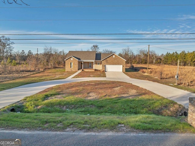 view of front of home with a front yard and a garage