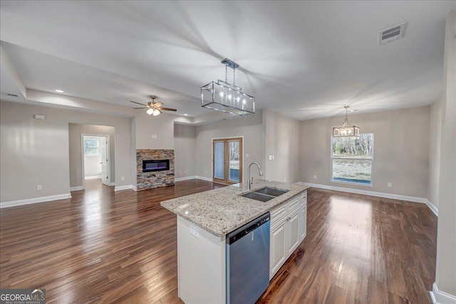 kitchen with stainless steel dishwasher, white cabinetry, sink, and pendant lighting