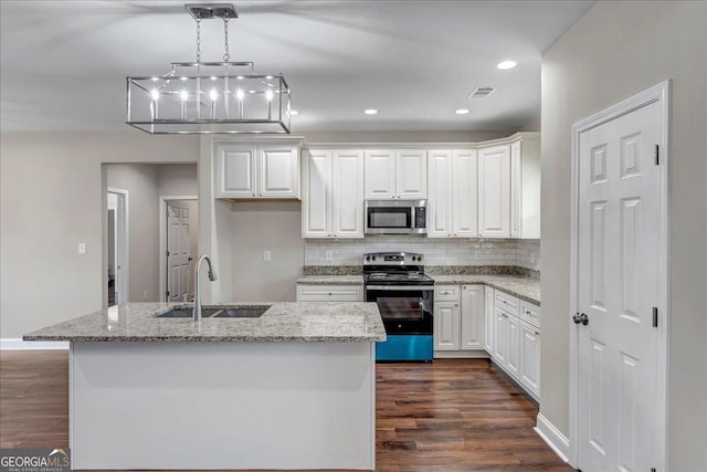 kitchen featuring sink, white cabinetry, an island with sink, light stone countertops, and appliances with stainless steel finishes