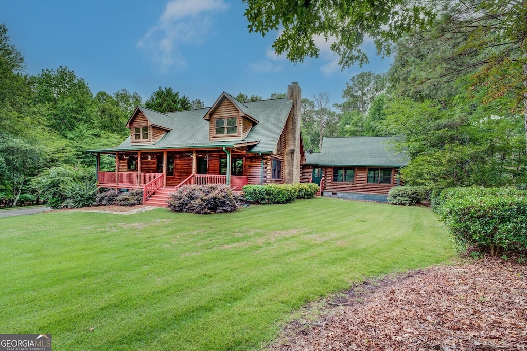 view of front of house with a front yard and covered porch