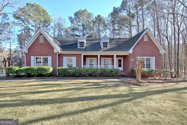 cape cod-style house with a porch and a front yard